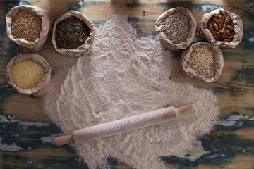 Tuinposter Grains, flour and rolling pin on wooden table © frameworks2014