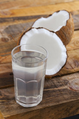 Coconut water and coconut fruit on wooden table