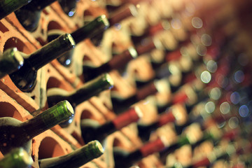 Wine cellar bottles covered with dust macro