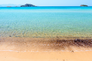 sandy beach and clear turquoise water of the sea