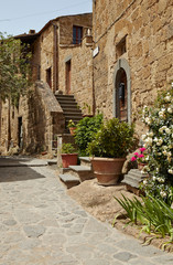 Obraz na płótnie Canvas Old small stone medieval street in historical town, Italy