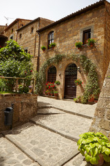 Fototapeta na wymiar Old small stone medieval street in historical town, Italy