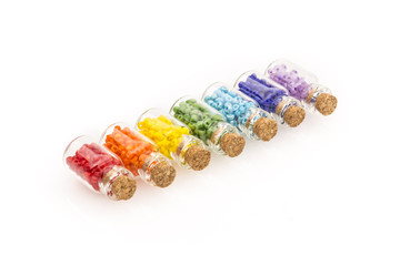 Tiny glass bottles filled with colourful beads