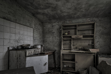 Dilapidated ramshackle kitchen in abandoned house