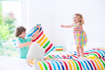 Adorable kids having pillow fight