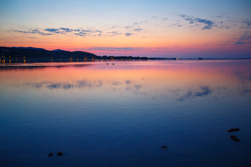 Beautiful sunset over water on Sardinia island