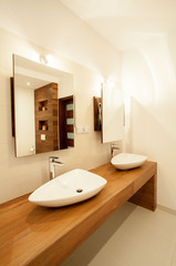Porcelain sinks on wooden counter