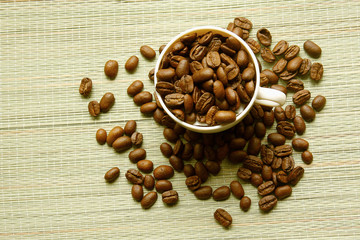 A cup and coffee beans, from above
