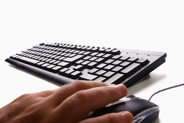 Close-up of male hand before touching button of black computer