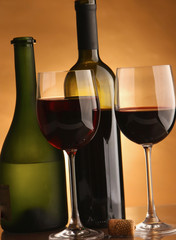 A glass of wine and a bottle