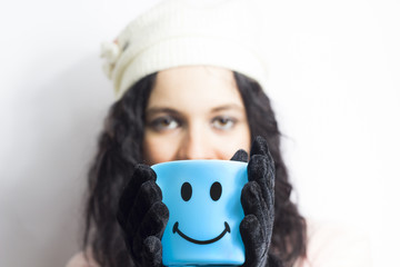 Winter Girl holding smiley cup
