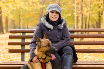 beautiful young woman with a dog in the park