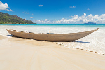 Old wooden fishing boat on sand