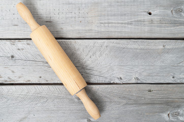 Rolling pin against old  wooden background