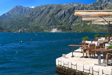 Fototapeta premium Street cafe in the town of Perast with views of the Bay of Kotor