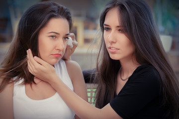Young woman comforting tearful friend