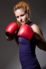 Beautiful girl with boxing gloves, dreadlocks.