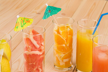 Tasty various juices on wood table.