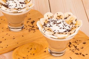 Delicious banana dessert on wood table.