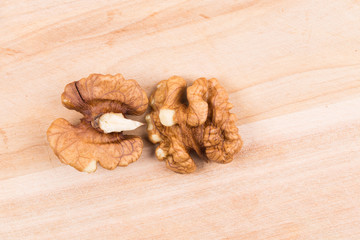 Walnut kernels on wood table.