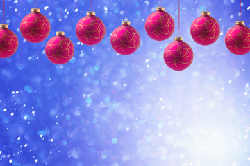 Christmas balls hanging over blue boke background