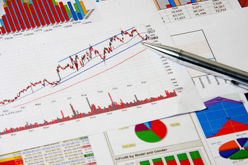Finance chart with pen on table