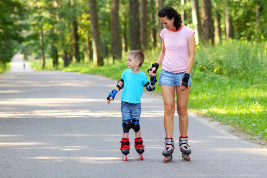 mother and son learn to roller skate. 