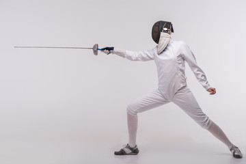 Fototapeta na wymiar Young woman engaging in fencing