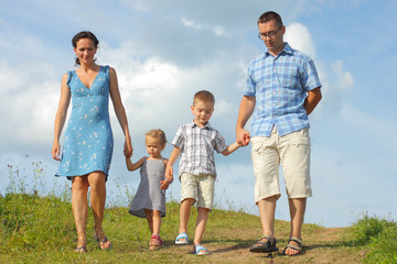 young happy family of four down from the mountains 