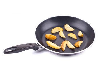 Frying pan with potatoes closeup
