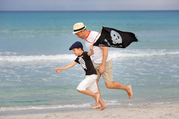 Boy and his father having fun on tropical beach