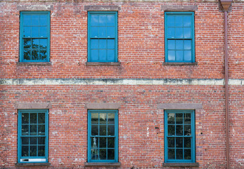 Six Green Windows on Old Brick Building
