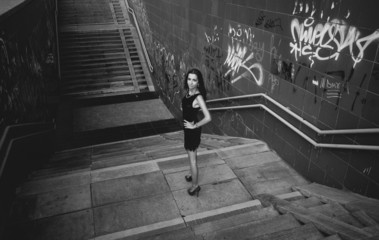 Monochrome shot of sexy girl posing on stairs
