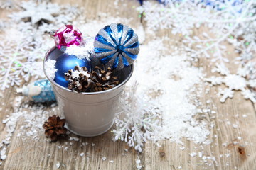 Fototapeta na wymiar Christmas ornaments in a decorative bucket