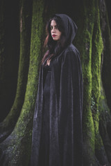 beautiful dark vampire woman with black mantle and hood