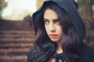 beautiful dark vampire woman with black mantle and hood