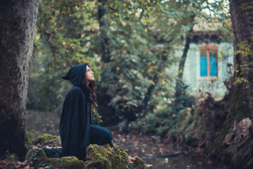 beautiful dark vampire woman with black mantle and hood