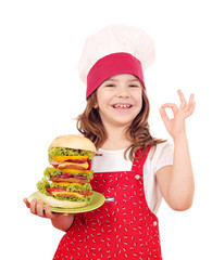 happy little girl cook with big hamburger and ok hand sign