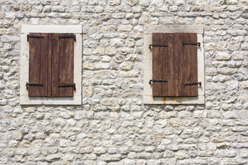 Windows in the old stone wall