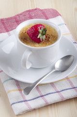 creme brulee with strawberry in a cup