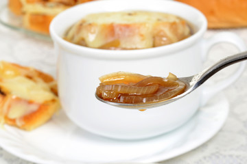 macro spoon of french onion soup shallow DOF
