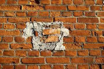 Old brick wall with added pieces.