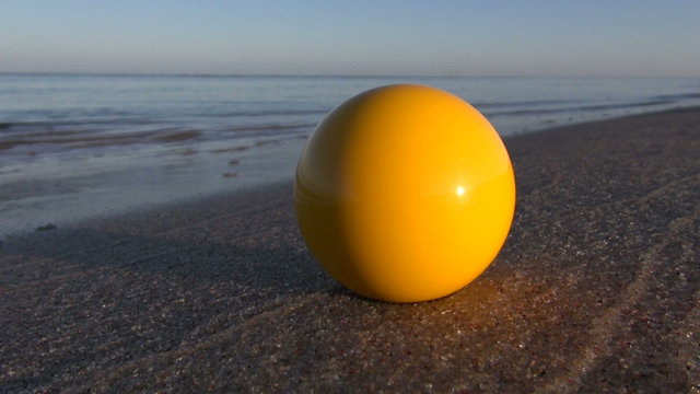 yellow billiards ball on summer sea resort beach