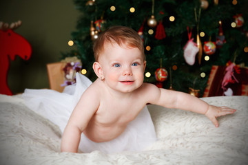 Happy baby around the christmas tree