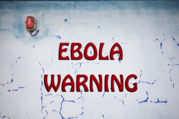Words Stop Ebola over grunge background wall