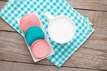 Obraz na płótnie Canvas Colorful macaron cookies and cup of milk