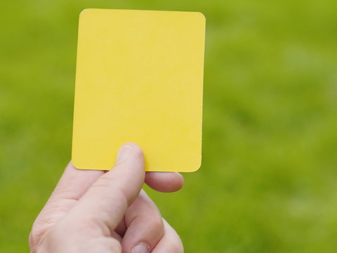 Referee Hand With Yellow Card