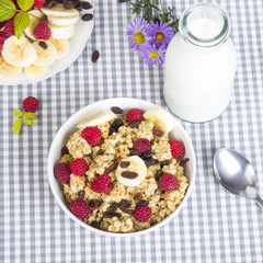 granola with fruits and bottle of fresh milk