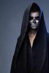 teenager with makeup skull cape