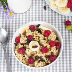 granola with fruits and bottle of fresh milk